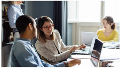 Man and woman look at a computer screen