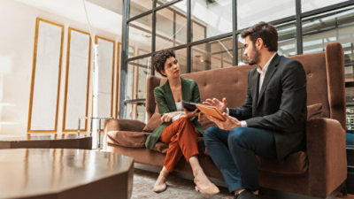 Business people talking while using a tablet in an office