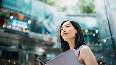 Woman holding tablet in a modern business district