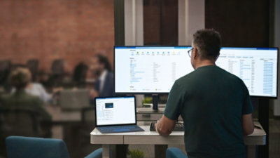 Man at work station looking at a computer screen