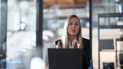 Business professional presenting at a laptop