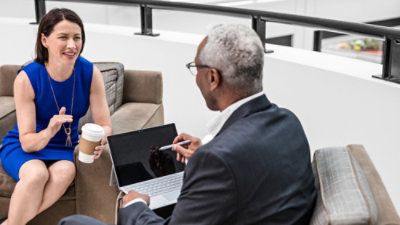Busines people talking and using a tablet
