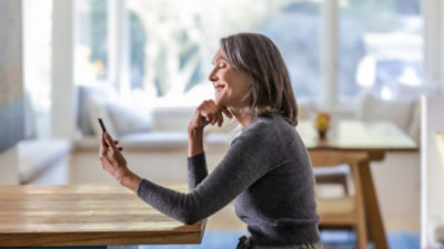 A woman looking at her mobile phone.