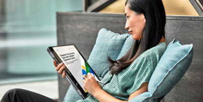 A person using a tablet to view the e-book titled Empower Your Security Team with a Modern Operations Center