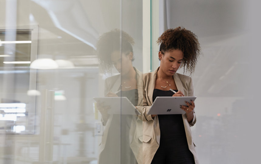 A woman uses a Surface Pro 7 tablet.