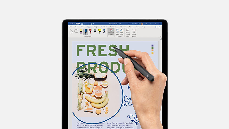A person’s hand designing with a Surface Slim Pen 2 for Business on a tablet.