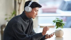 A man is looking up information on his phone.