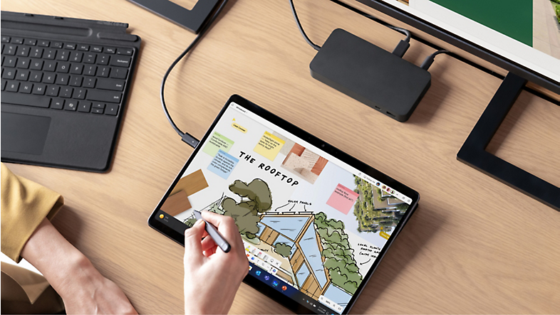 A person drawing on a tablet