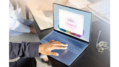 An adult using Microsoft Copilot on Surface Laptop 7th edition Copilot PC in Sapphire.