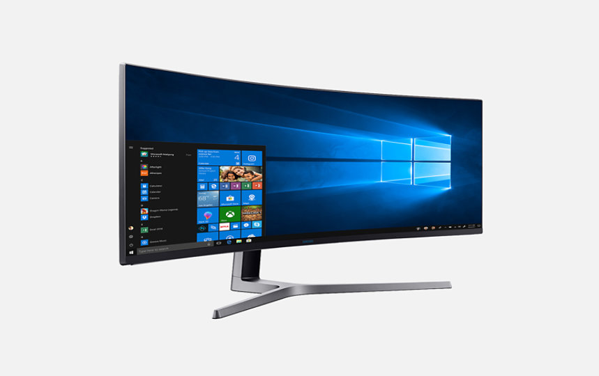 Angled front view of Samsung C H G 9 0 Q L E D gaming monitor with Windows home screen on display.