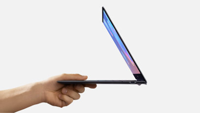 A hand easily holding the Samsung Book S. 