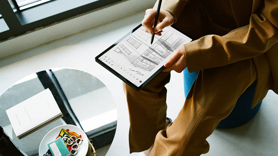 A person using the Samsung Galaxy Tab S7 in tablet mode on their lap.