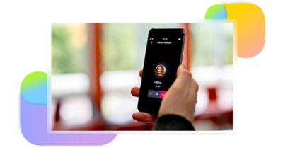 A hand holding a mobile phone making a call in Teams.