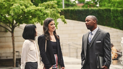 Two women and a man having a conversation