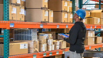 Man in warehouse using a tablet