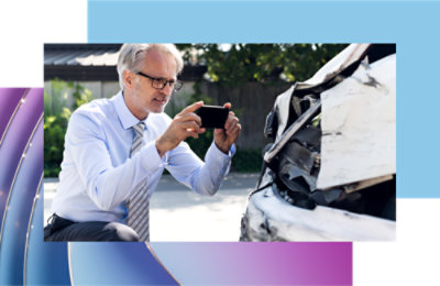 A man taking a picture of a car.