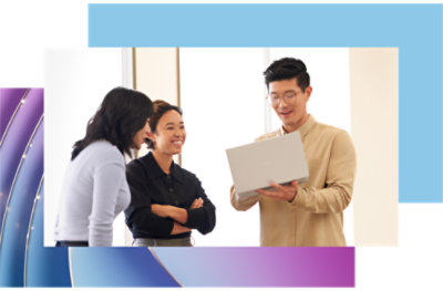 A group of people standing around a laptop.