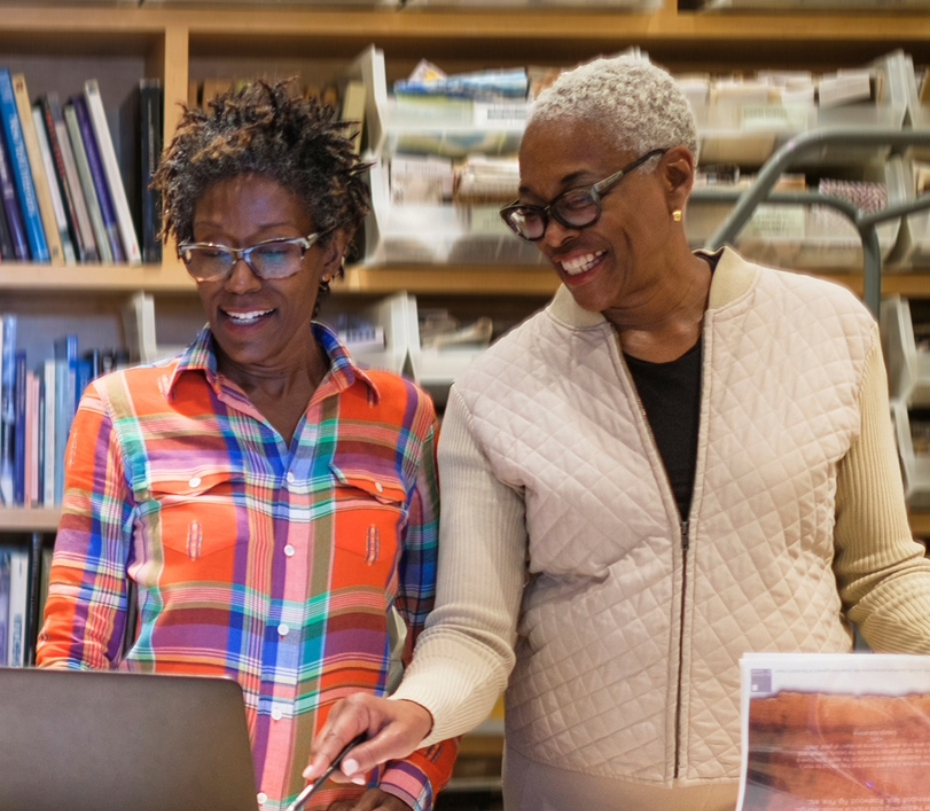 Women using a laptop in an office.
