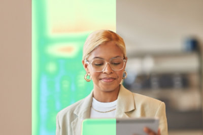 A woman looking at a tablet.