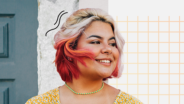 Photo of a smiling woman against a colorful background.