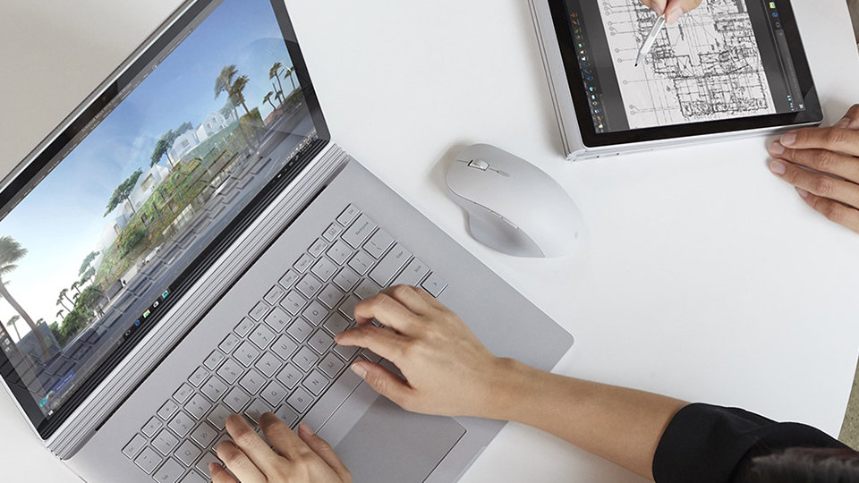 Photograph of Surface Book with Surface Precision Mouse sitting next to it.