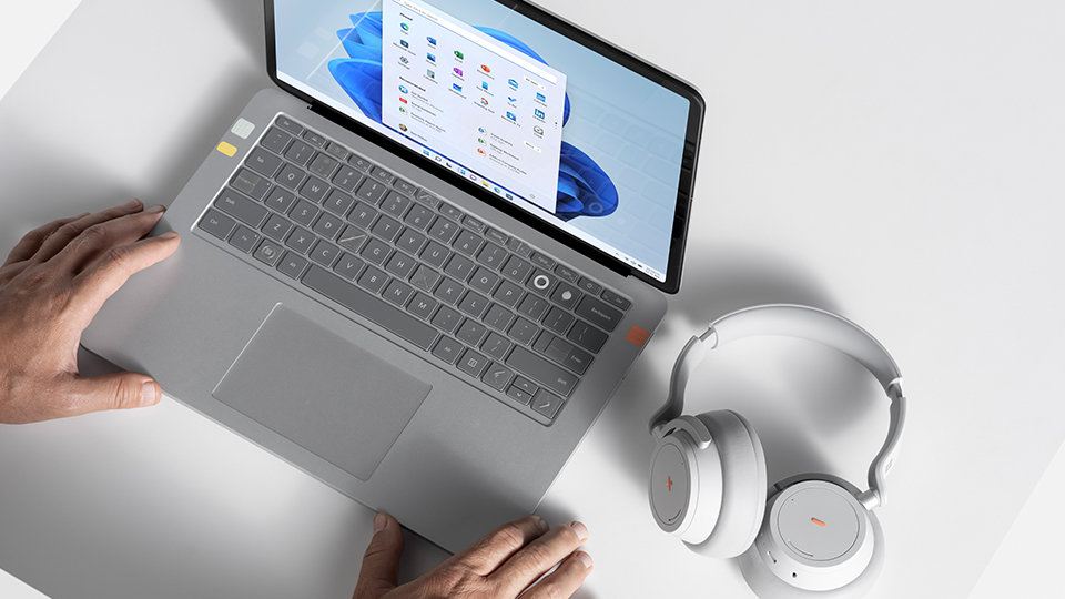 A person’s hands touching a Surface device that’s been customized with the Adaptive Kit. 