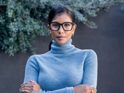 A woman wearing glasses and a turtleneck.