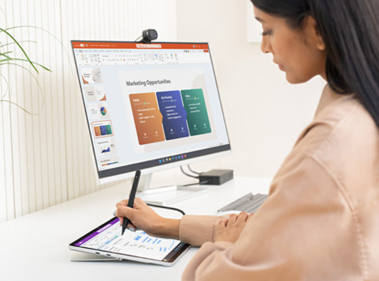 A person uses a Surface Pen to write on Surface Pro 9 for Business in tablet mode. 