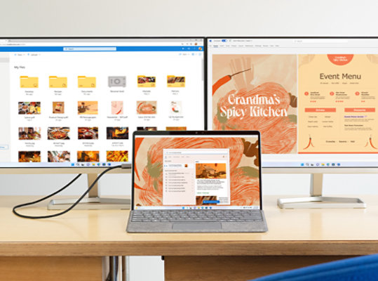 Surface Pro 9 for Business sits open on a desk, connected to two external monitors.