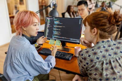 A woman and a man looking at a computer screen.