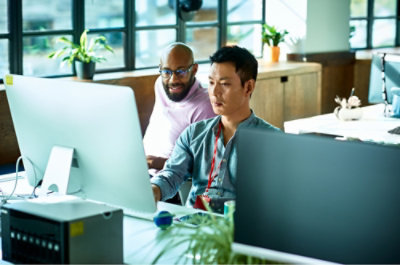 Two colleagues working together at a computer