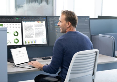A person sitting at a desk with a laptop.