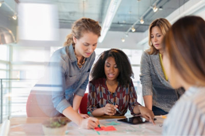 A group of women looking at a tablet.