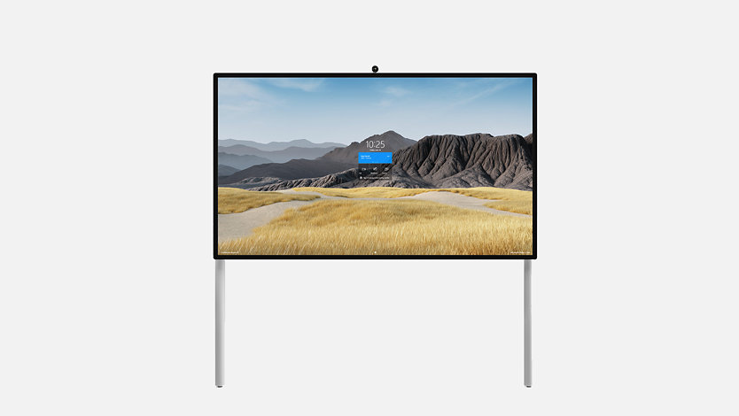 Un Surface HUB 2S 85'' sobre un soporte de pared con soporte para el suelo.