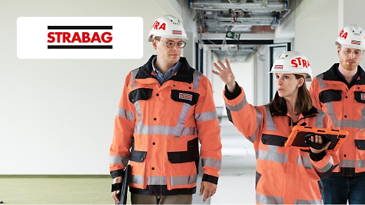 Three Strabag employees wearing protective hats and clothing having a conversation