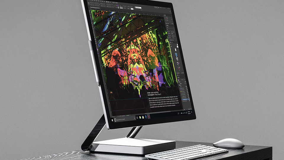 Surface Studio 2 for Business with a mouse and keyboard on a desk.