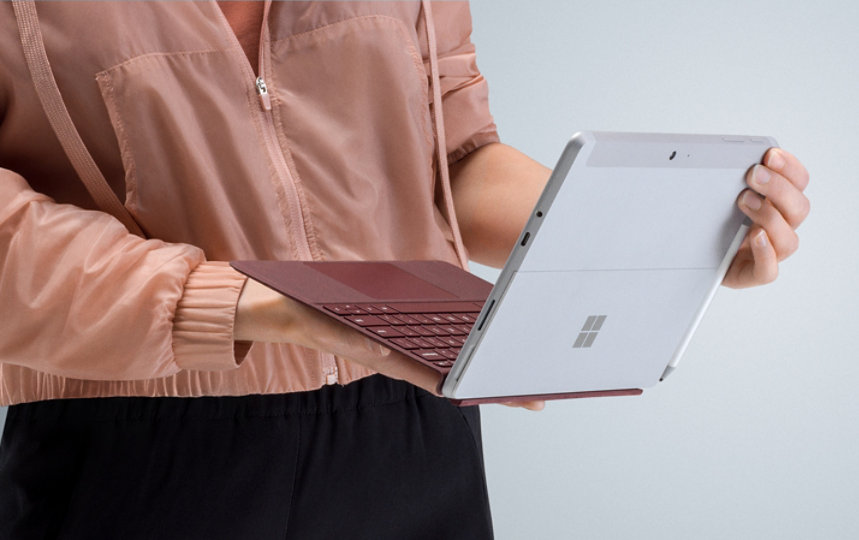 A person holding their Surface Go device.