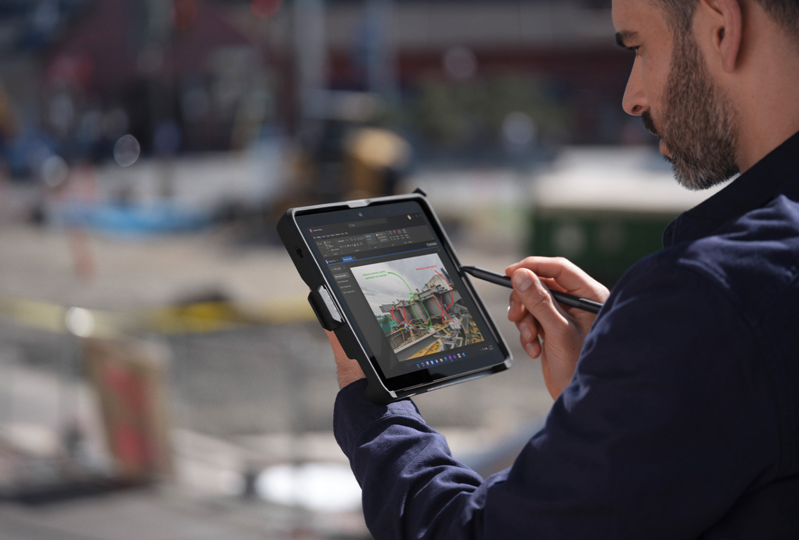 A person on-the-go at a jobsite uses Surface Pen to navigate Surface Go 4