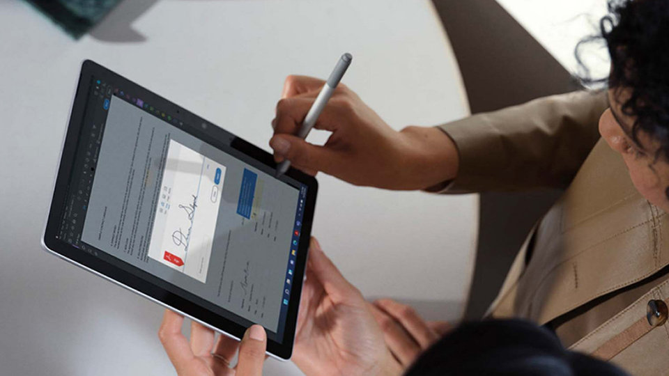 Člověk naviguje na zařízení Surface Go 4 pomocí pera pro Surface