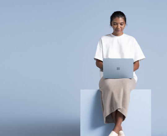 Person typing on Ice Blue Surface Laptop 4