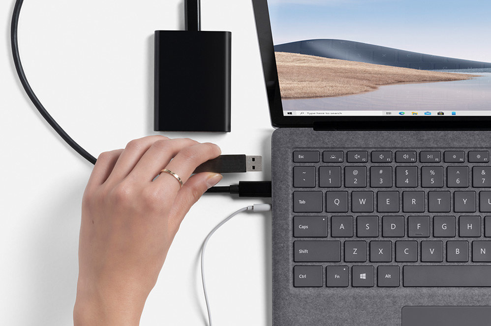 Multiple cables connected to Surface Laptop 4.
