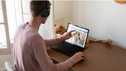 A person touches the Surface Laptop 3 screen for a creative project.