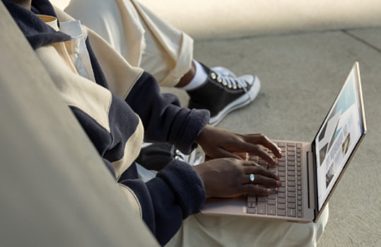 A person types on the full-size keyboard of Surface Laptop Go.