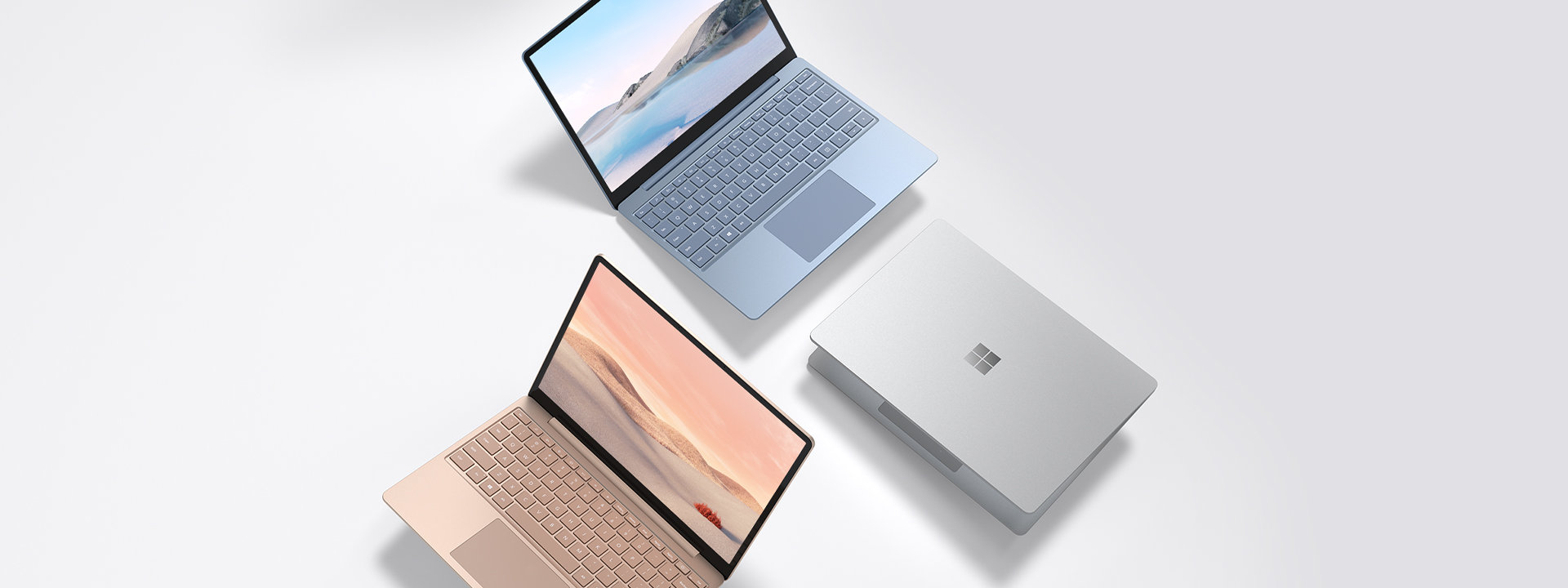 A series of Surface Laptop Go in sandstone, platinum and ice blue