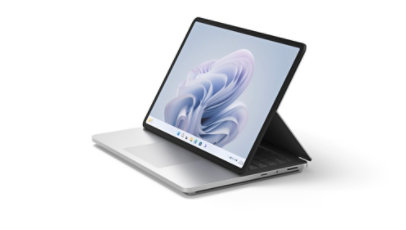 Surface Laptop Studio 2 shown from a side angle in Stage Mode with a Windows bloom on screen.