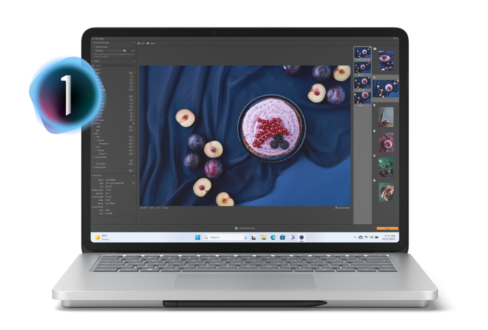 Surface Laptop Studio 2 showing a fruit pie flanked by ripened plums on a dark blue table cloth on the device screen with Capture One menu items popping out of the display.