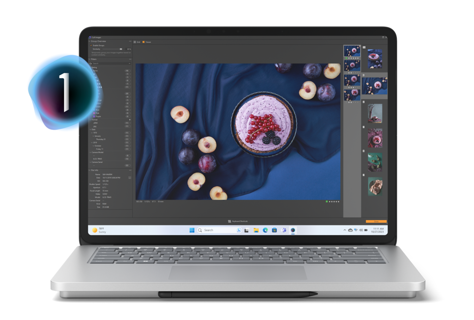 Um Surface Laptop Studio 2 a apresentar uma tarde de fruta rodeada por ameixas maduras sobre uma toalha de mesa azul escura no ecrã com itens do menu do Capture One a saltarem do ecrã do dispositivo.