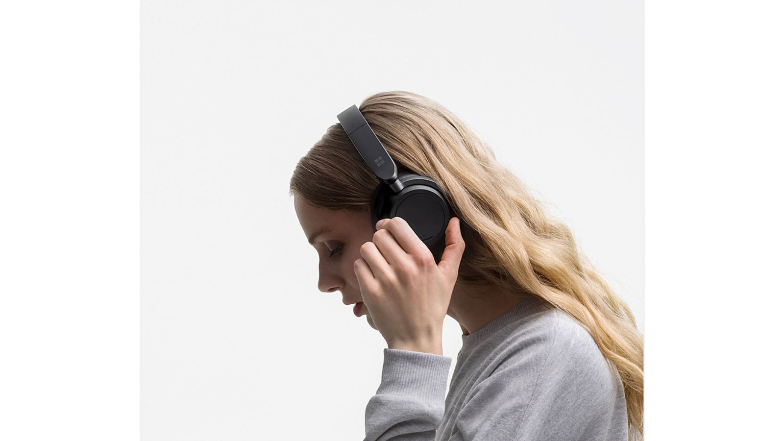 A person is shown wearing Surface Headphones 2