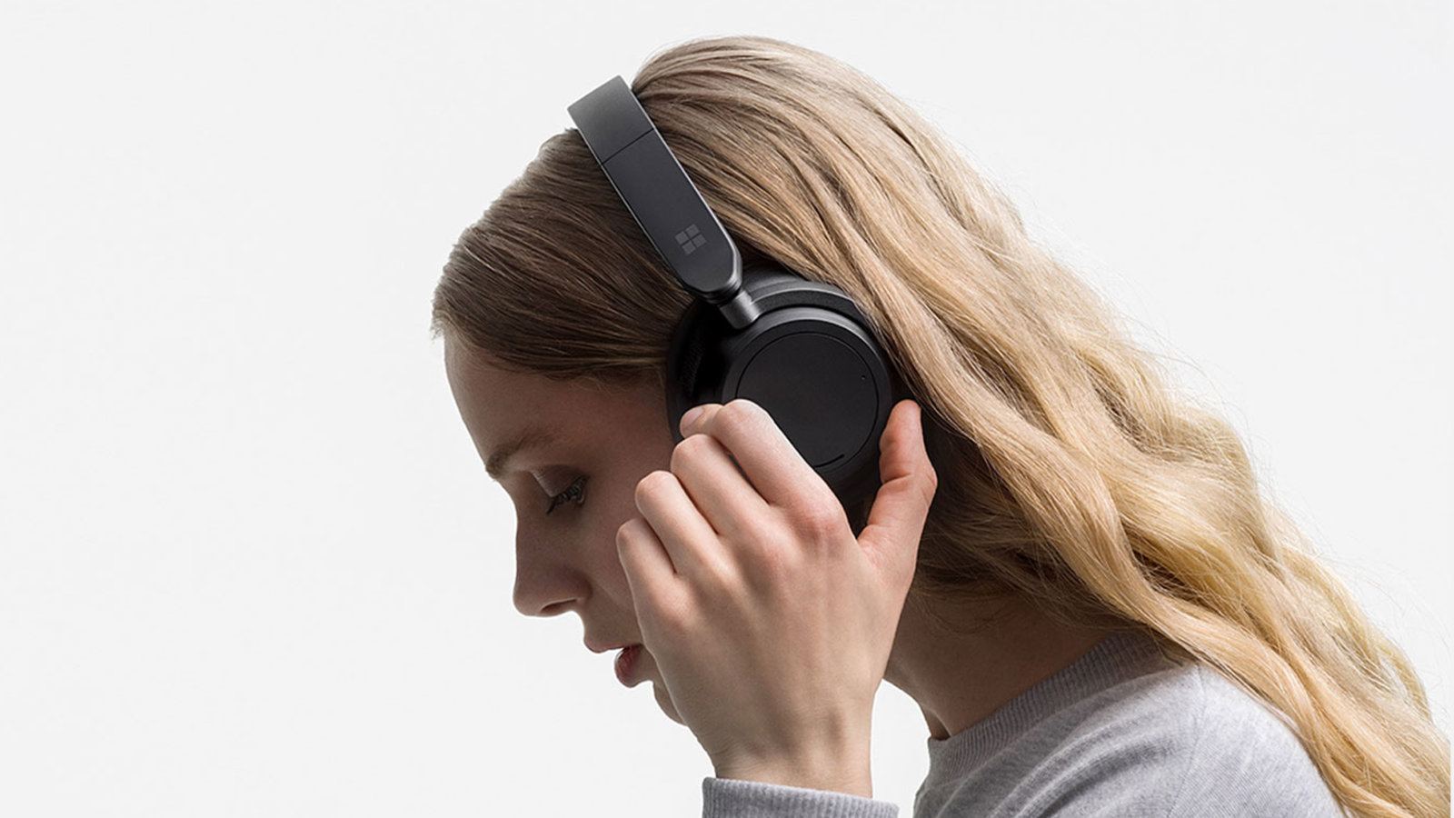 A person is shown wearing Surface Headphones 2