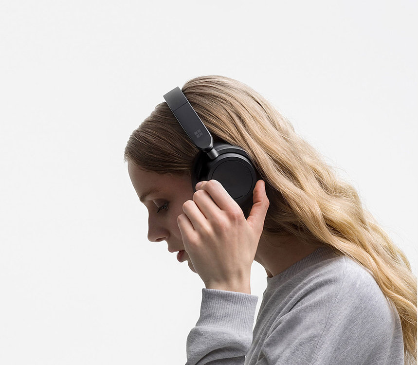 A person wears a pair of Surface Headphones.